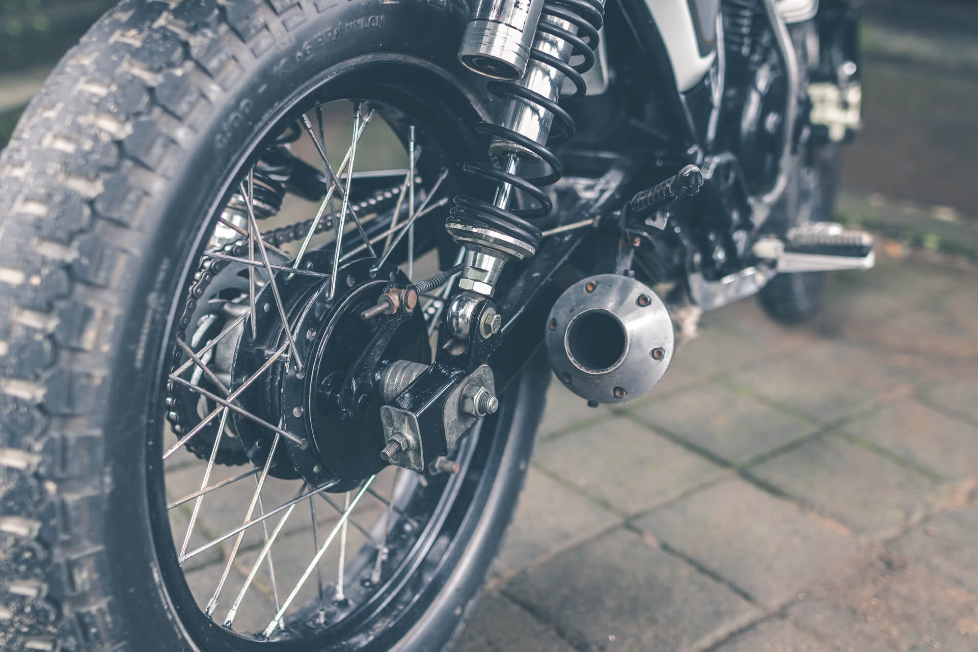 Close up of a motorcycle exhaust pipe and back tire