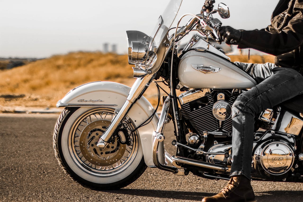 man sitting on a Harley-Davidson motorcycle on the road