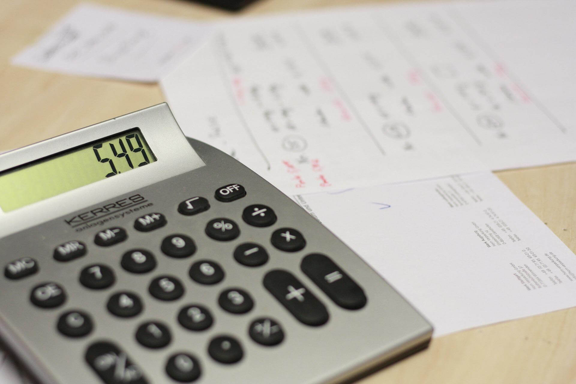 calculator on a table with invoices