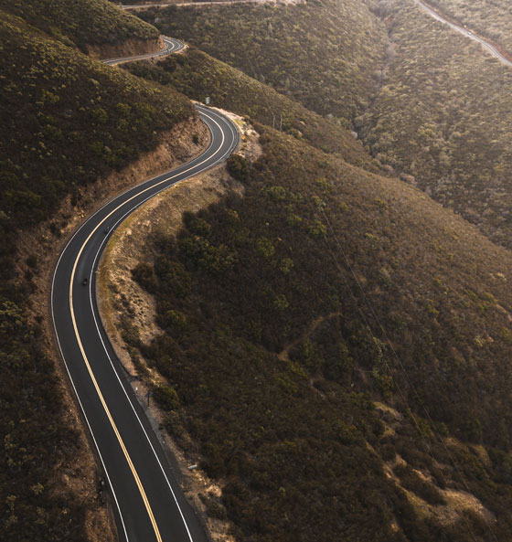 a biker rides a curvy road