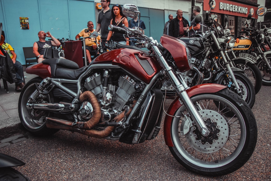 Bikes of various styles and designs parked at a meet