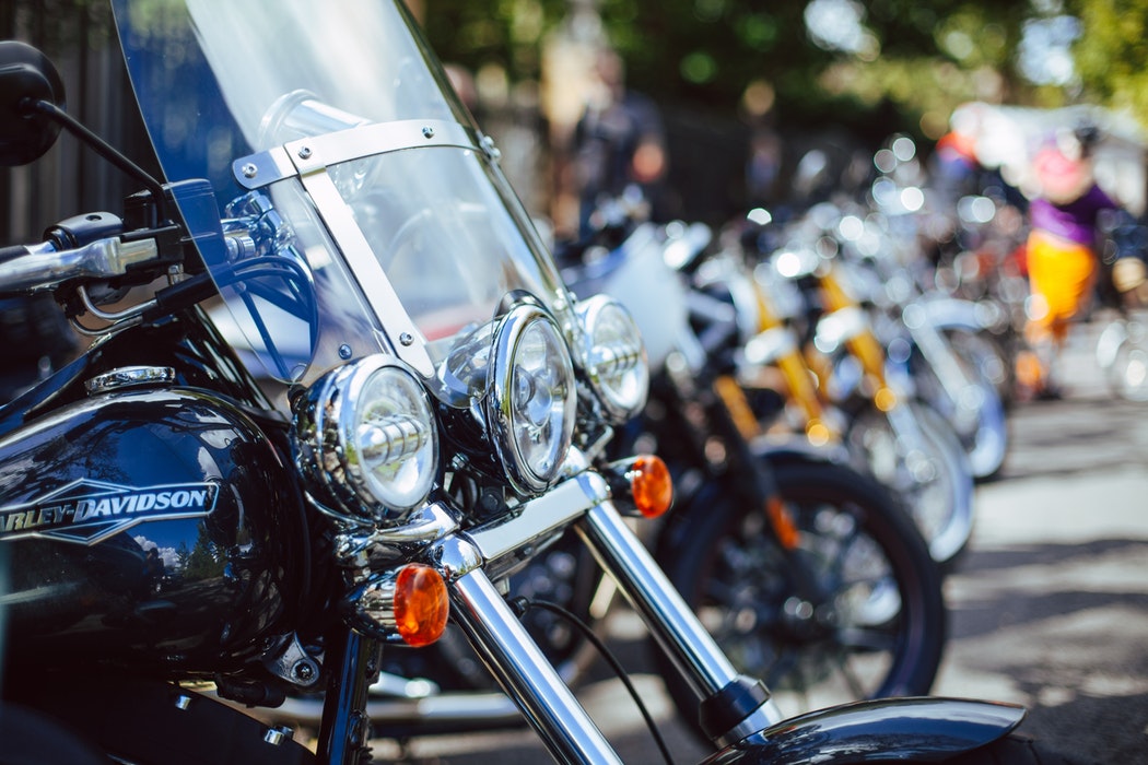 A line of motorcycles of various makes and models