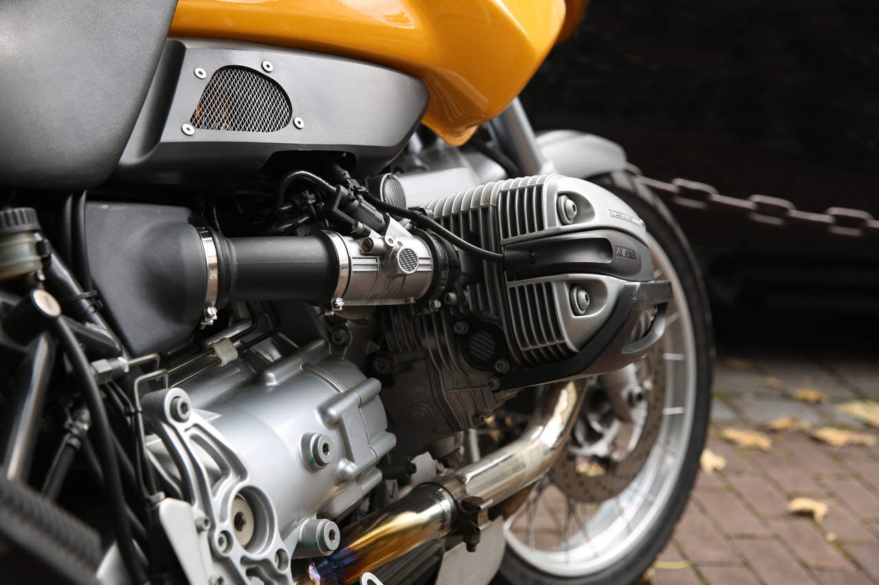 Close up photo of a yellow motorcycle’s engine