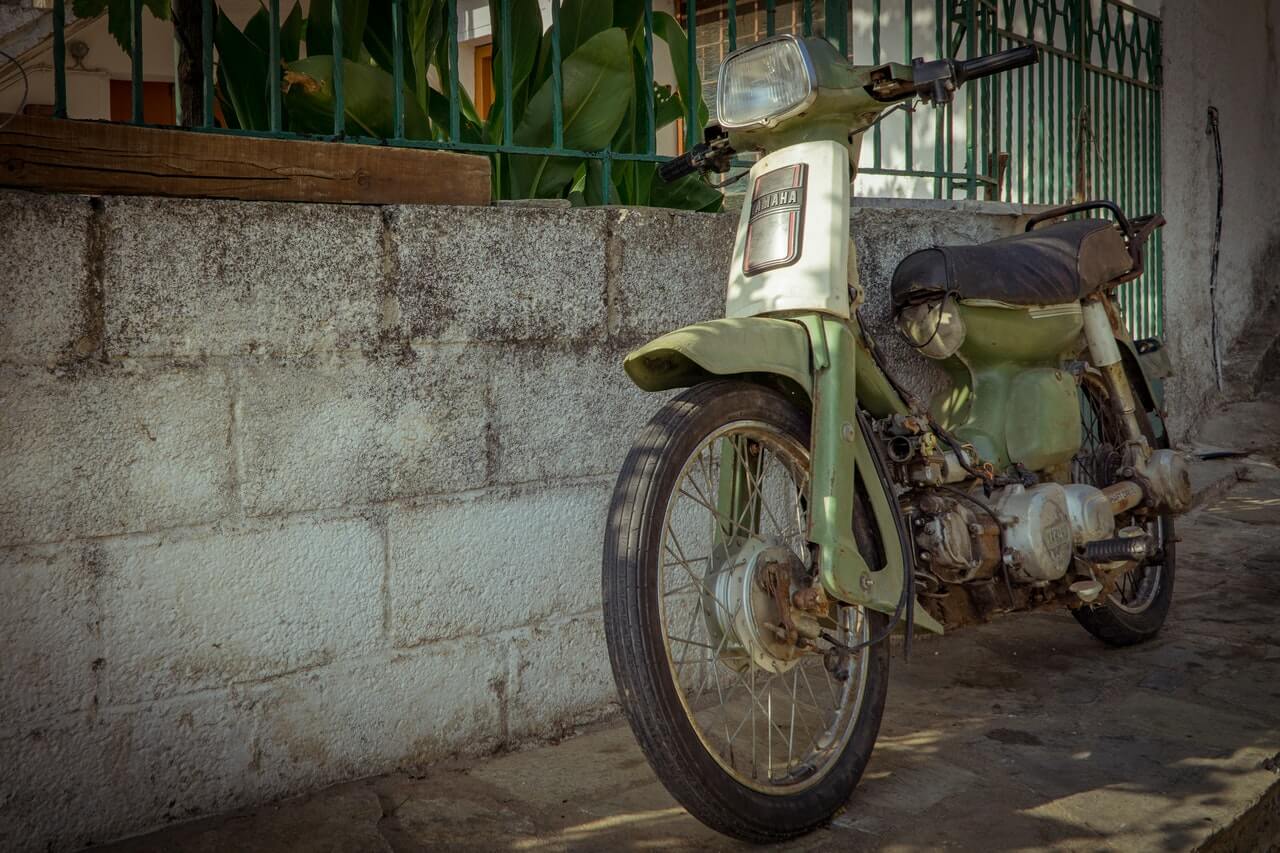 Rusty green retro Yamaha motorcycle