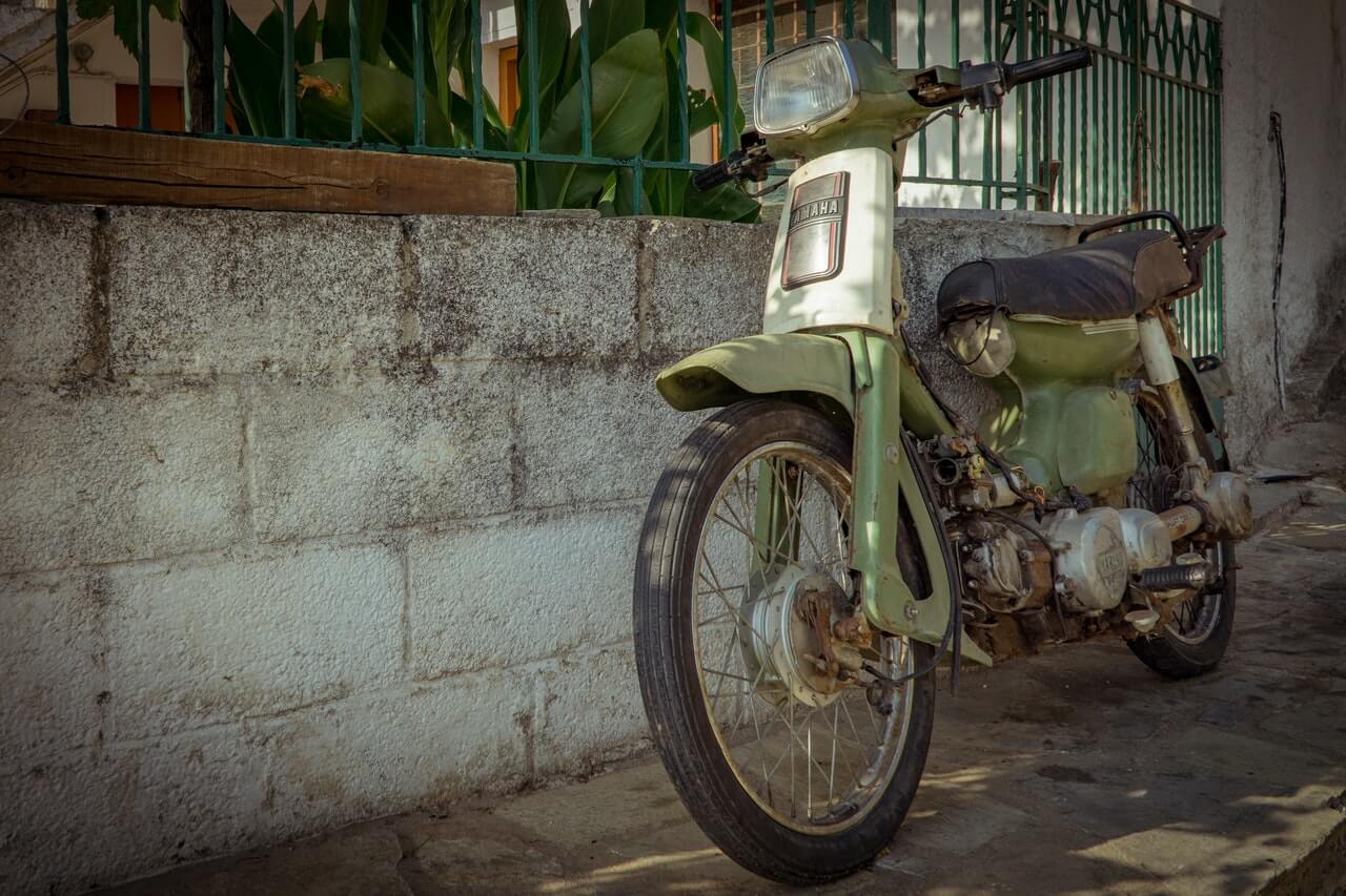 Rusty green retro Yamaha motorcycle