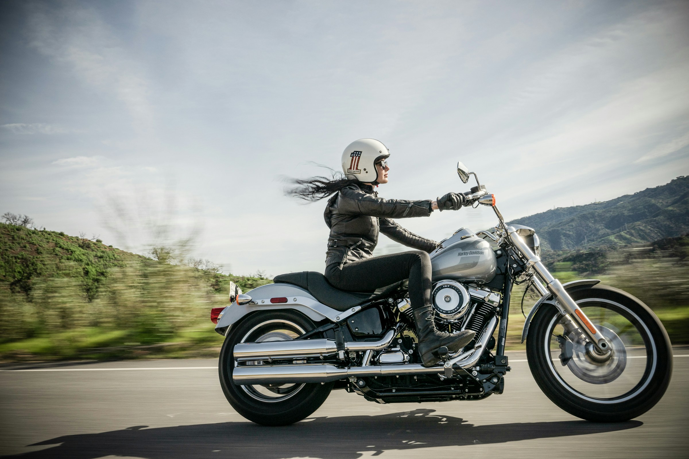 Woman riding a Harley-Davidson motorcycle