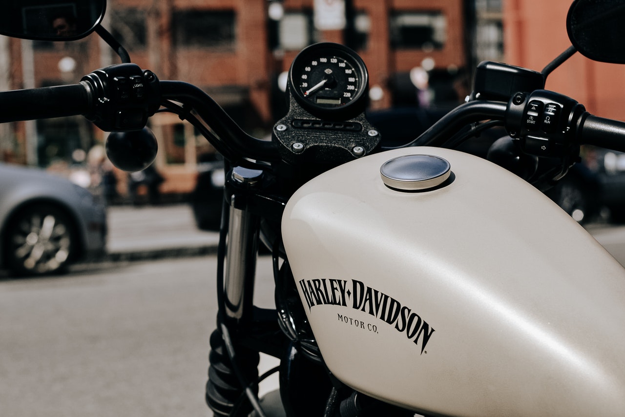Up close photo of the front of a white Harley Davidson from the driver’s point-of-view