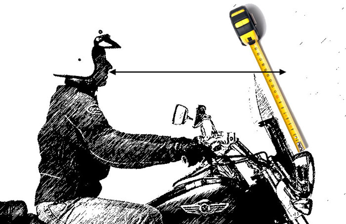 Extended measuring tape laid on sketch of man on motorcycle