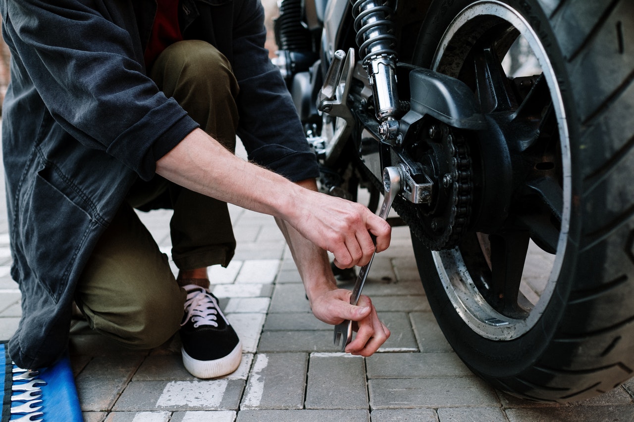 Man adjusting motorcycle tire