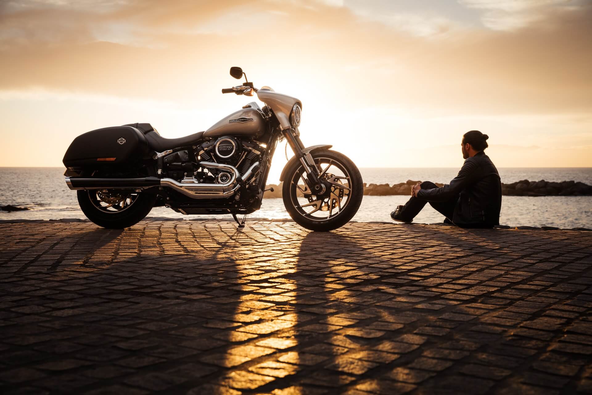 Man sitting next to his motorcycle