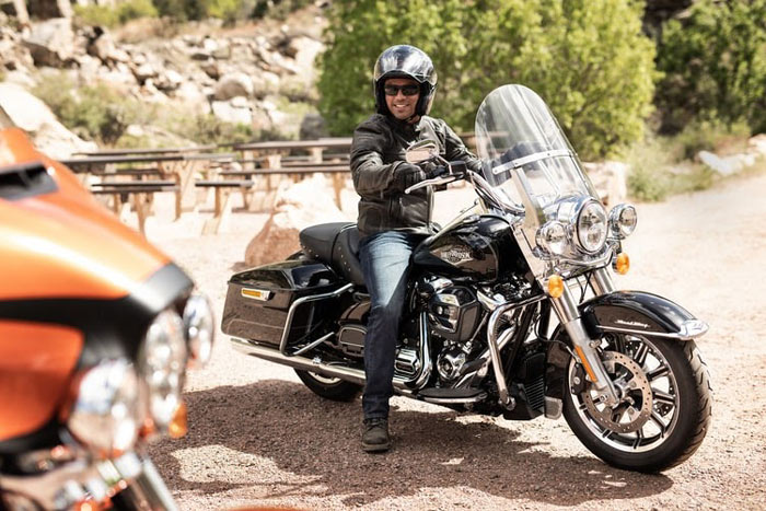 man sitting on a black and gray touring motorcycle