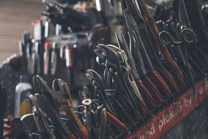 A selection of mechanics tools with some spaces in the rack empty