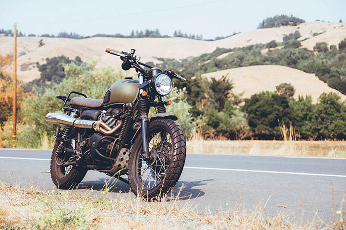 a motorbike is parked on the side of a highway