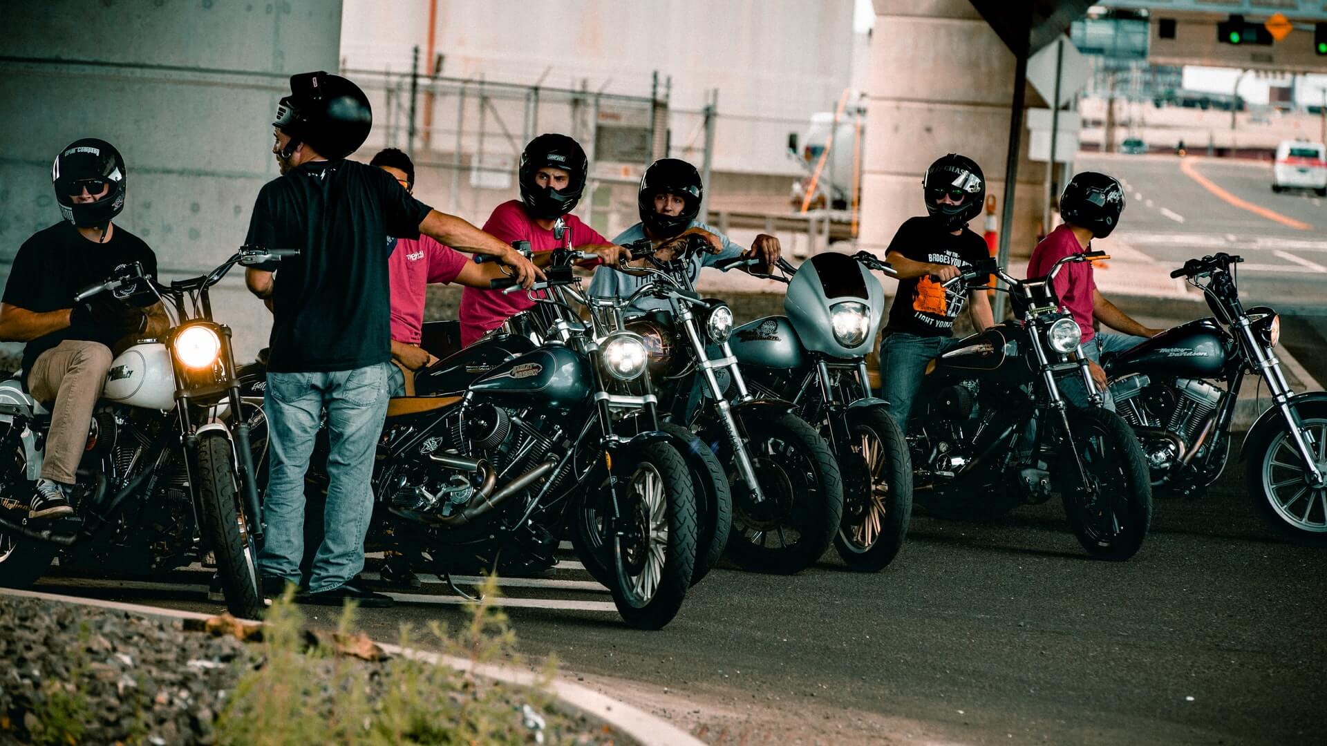 Group of many men hanging out on their motorcycles