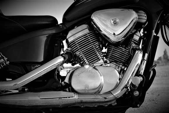 A Honda VTX 1800 motorcycle engine, shown in black and white.