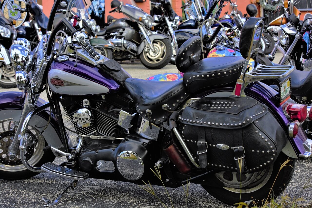 A bunch of motorcycles with focus on a purple motorcycle