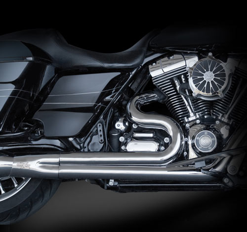 Side of black motorcycle with engine and chrome muffler