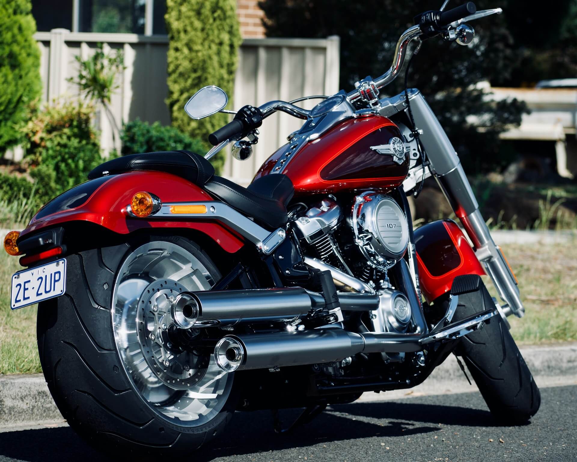 The back of a red motorcycle with two exhaust pipes