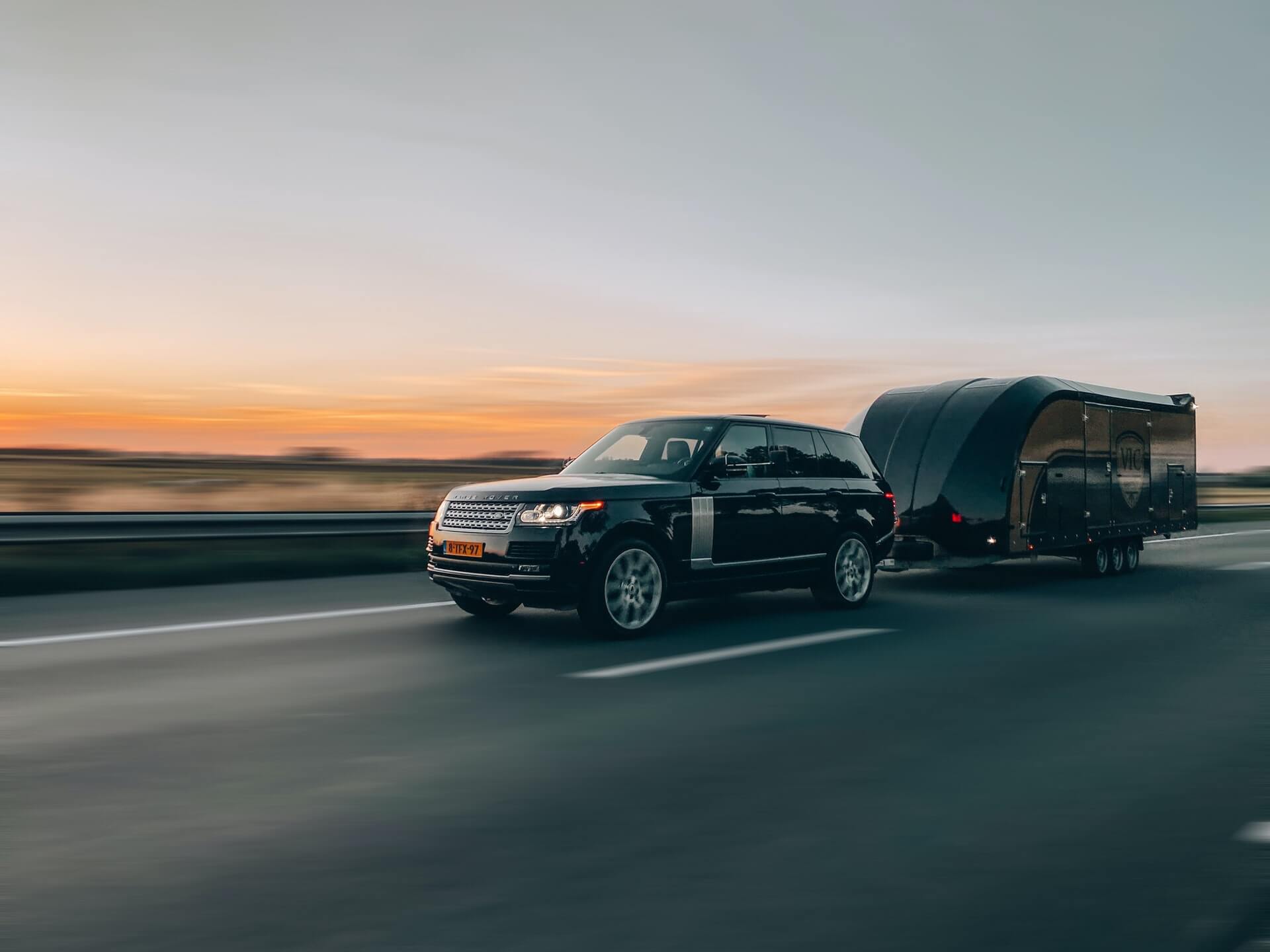 SUV pulling motorcycle transport trailer