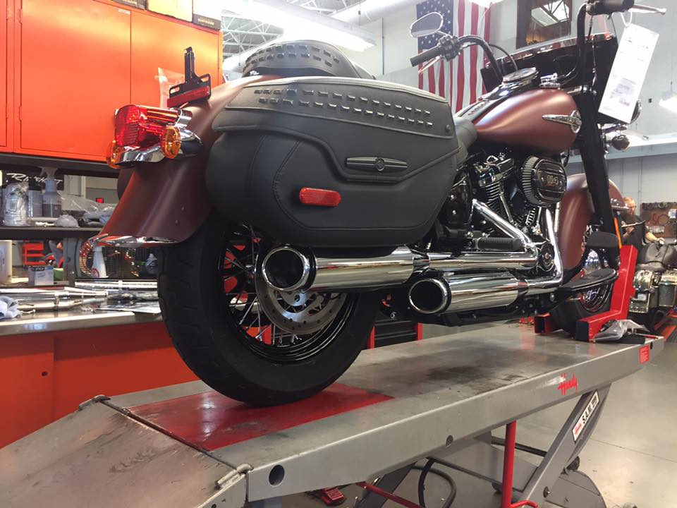 Chrome exhaust pipes on black and brown motorcycle