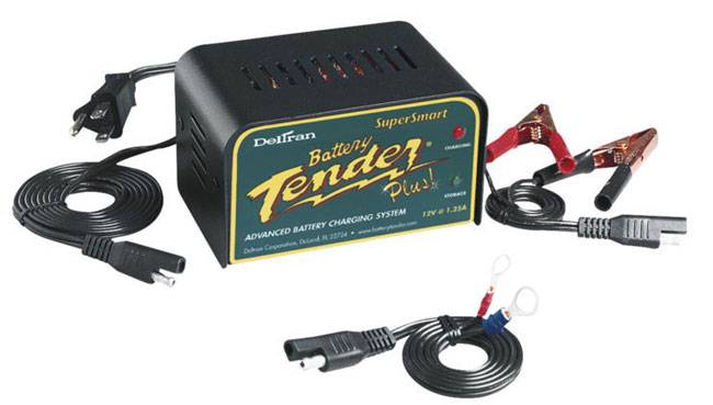 A DelTran SuperSmart Battery Tender Plus! advanced charging system is shown in use for winter motorcycle storage.