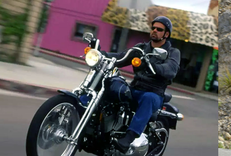 man riding a harley davidson high-impact motorcycle