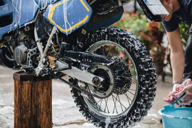 Close up of someone washing their motorcycle