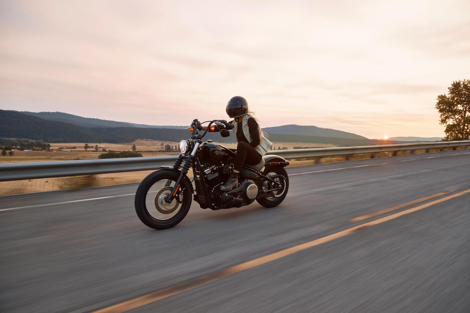 Woman riding a motorcycle at dusk